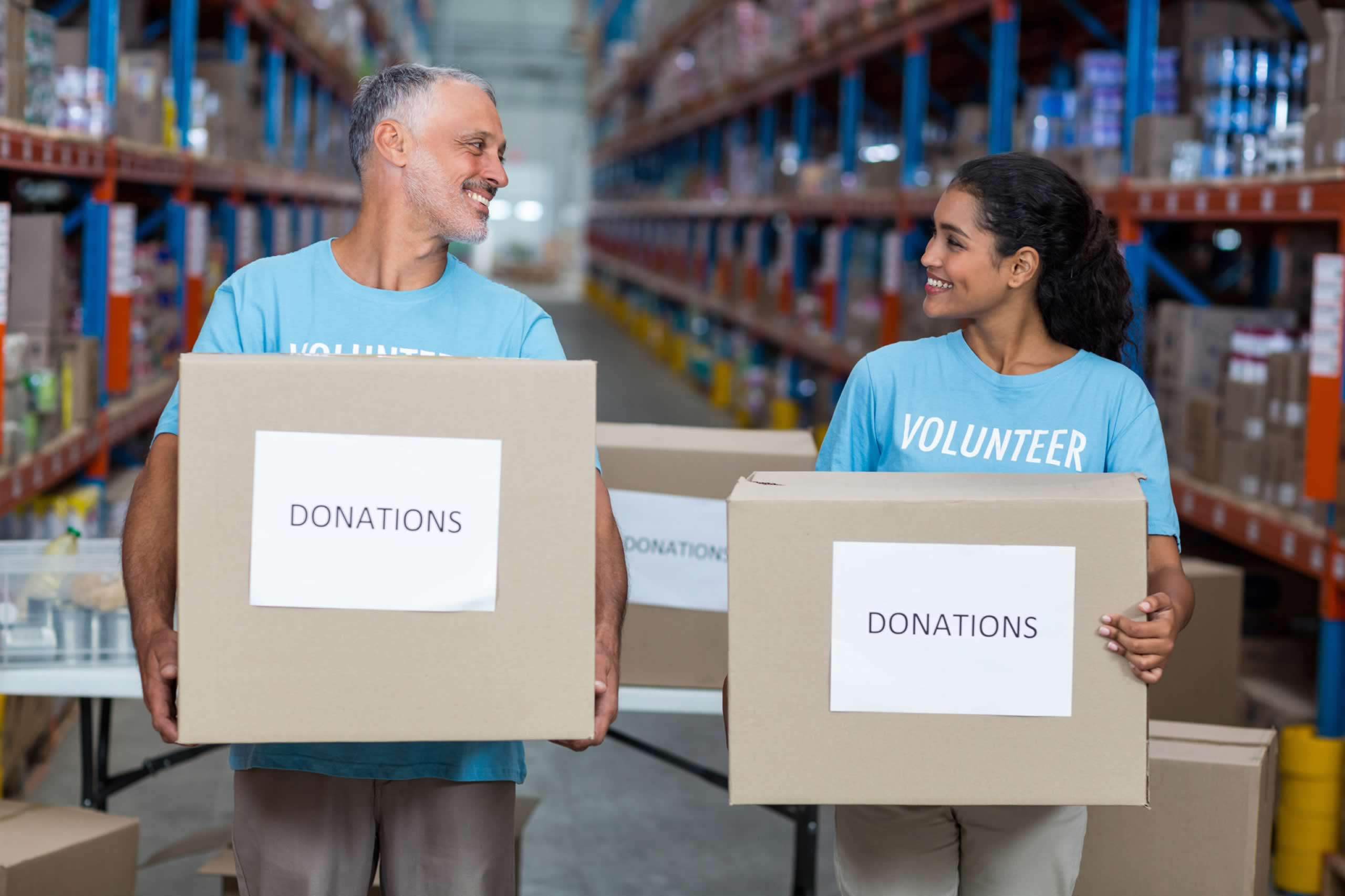 Man-and-woman-holding-boxes-marked-donations